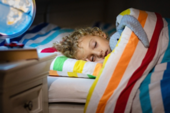 child in bed asleep