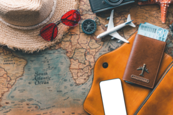 travel map, sun hat, camera, phone, toy plane, passport wallet