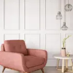 pink armchair with wood panelled walls behind