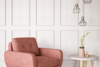 pink armchair with wood panelled walls behind