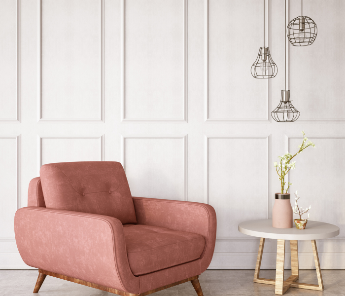 pink armchair with wood panelled walls behind