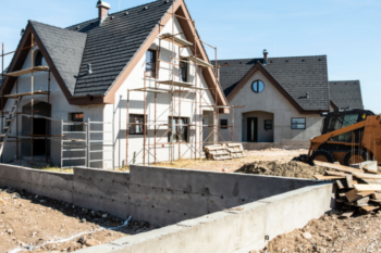 new build home with scaffolding around it