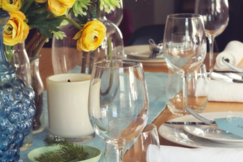 table with glases and yellow flowers