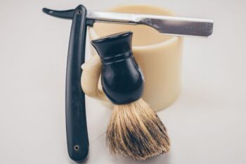 straight razor next to shaving brush
