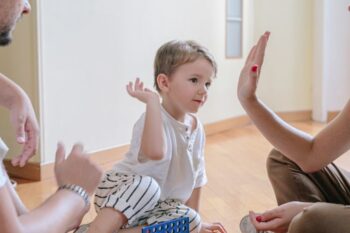 child playing connect 4 with parents