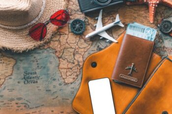 map with sunglasses, hat, passport etc on