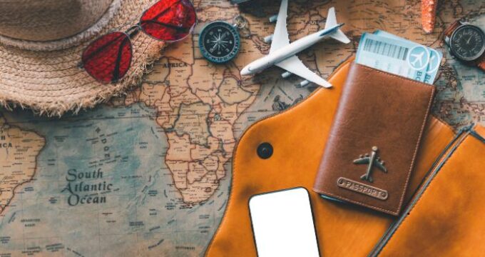 map with sunglasses, hat, passport etc on