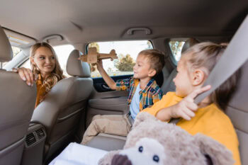 children and mum in car