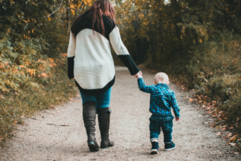 mum and son walking in country path