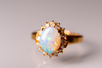 gold ring with diamonds and pearlescent centre