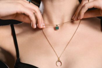 close up of woman showing gold necklaces
