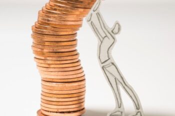 person keeping pennies built up in tower