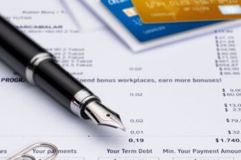 credit cards, fountain pen and credit card statements