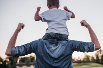 dad with son on his shoulders