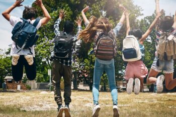 kids jumping in air, back towards camera