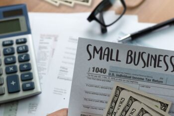 cash, calculator, glasses and invoices
