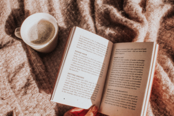 book and coffee on blanket