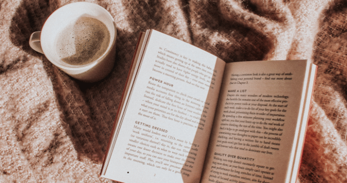book and coffee on blanket