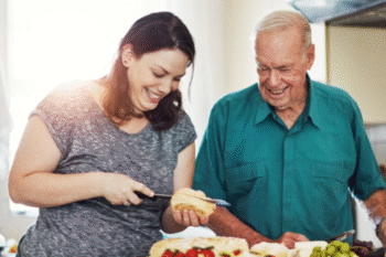 father and daughter in kitchen preparing food