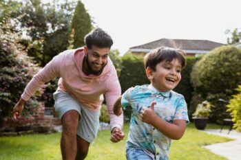 dad and son playing in garden
