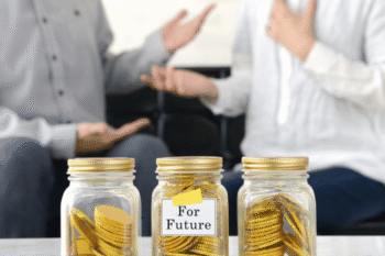 couple sat behind three jars of money