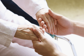 elderly hands holding younger hands