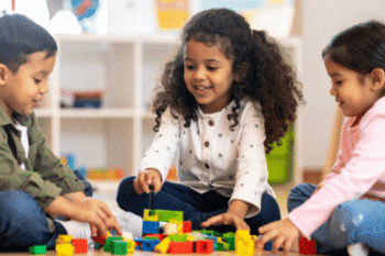 three kids playing with blocks