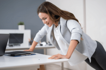 woman doing push up against a desk