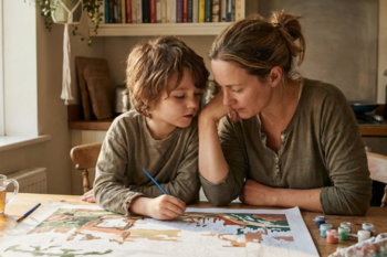 Parent and child enjoying a screen-free paint by numbers session together