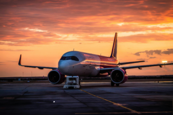 Aircraft parked on the tarmac during sunset, ready for departure before a holiday trip.