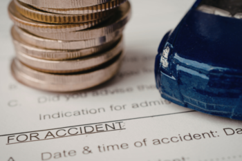 car insurance form, coins and toy car