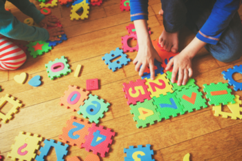 child playing with number and bright jigsaws