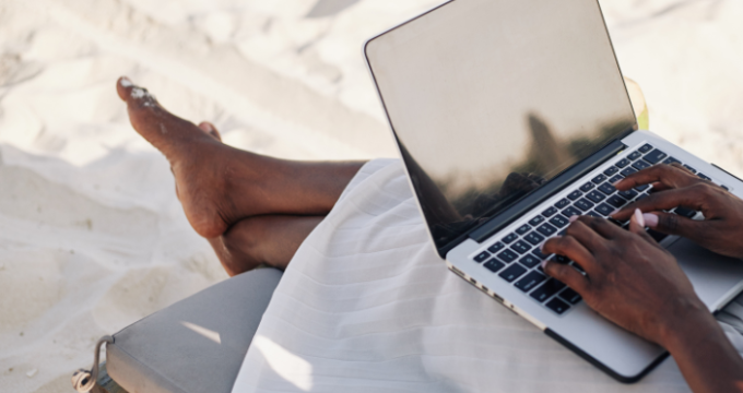 working on a laptop on beach
