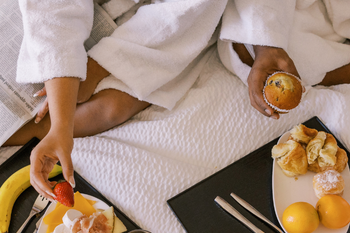 a couple eating breakfast in bed